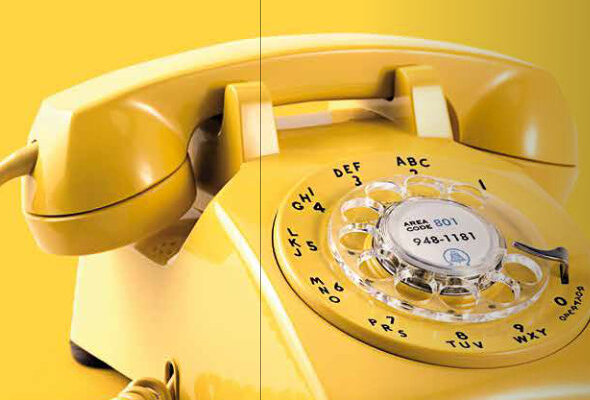 Gelbes Telefon mit Wählscheibe